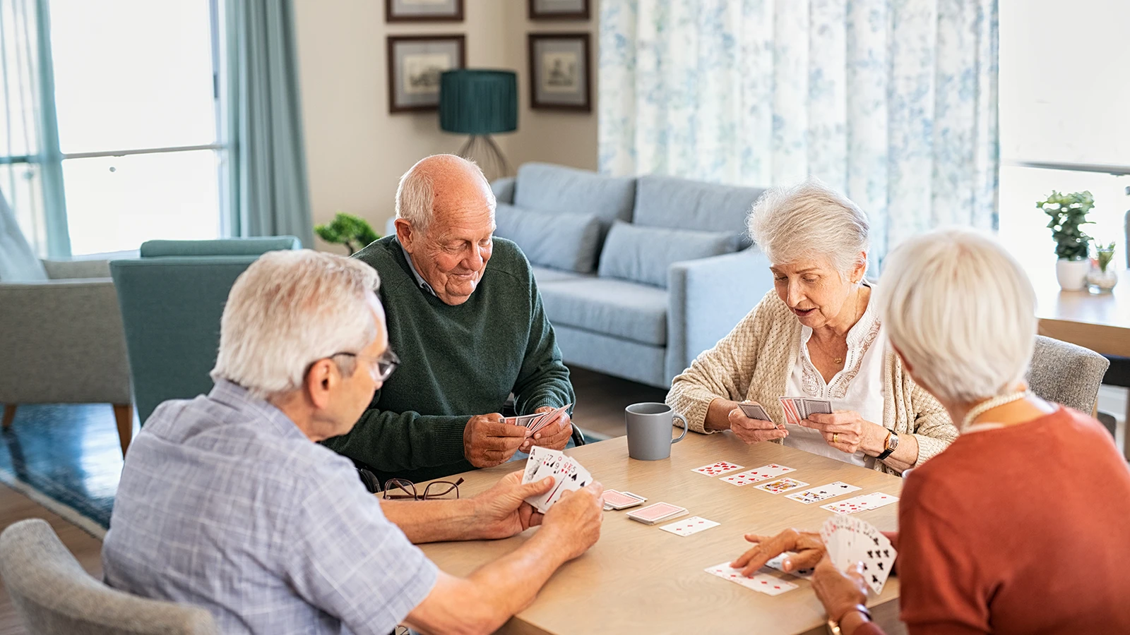senior-friends-playing-cards-together-at-nursing-home