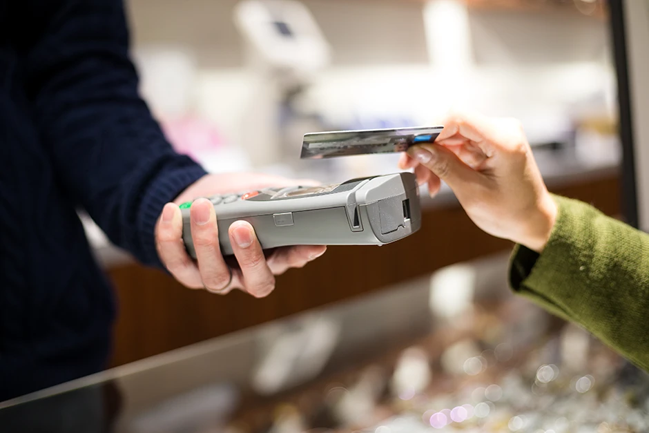 woman paying with mobile phone by nfc